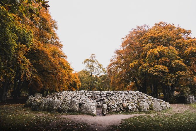 A Bronze Age burial cairn at Clava, ringed by kerb stones and autumn trees