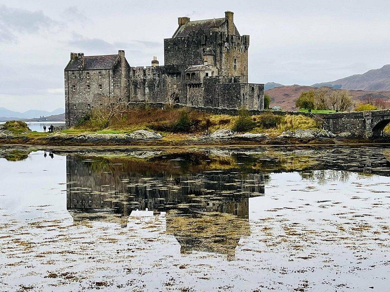 Eilean Donan Castle on its island, mirrored in the still water around it