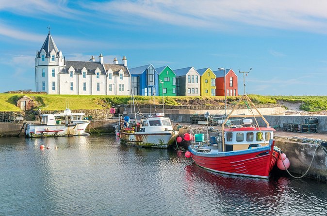 Fishing boats and the painted gable ends of the harbour at John O'Groats